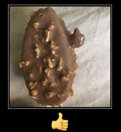 [an image of a chocolate candy bar with nuts. a bit of chocolate sticks out from the side, in a shape that resembles a thumbs up. the image is part of a demotivational, with the caption simply being the thumbs up emoji]
